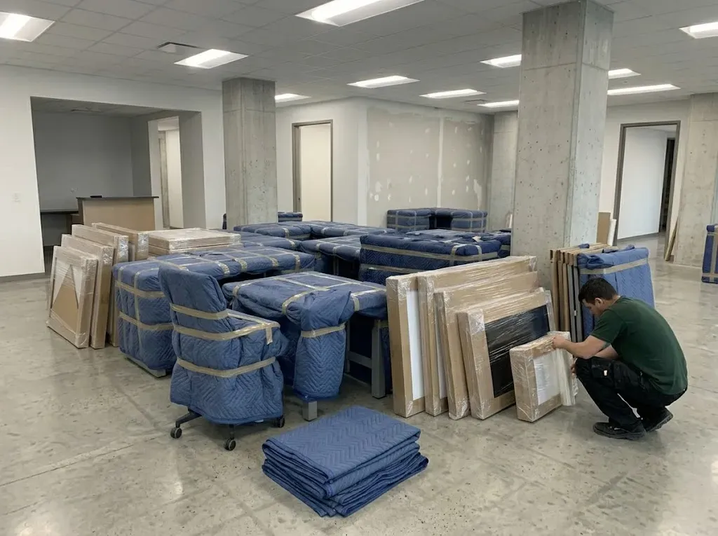 Inventory specialist inspecting cardboard-wrapped furniture in a Vaughan home